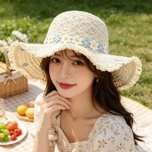 Outdoor picnic scene showcasing detailed crochet daisy flowers and wide brim straw sun hat.
