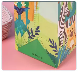 Close-up detail of plastic gift bag with jungle animal print, showing bottom construction.