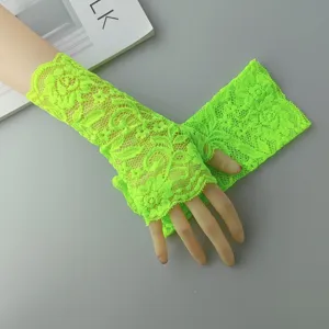 Neon green lace fingerless gloves detail view, showing delicate hollow floral pattern.