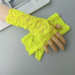 Neon yellow lace fingerless gloves close up detail showing floral hollow out design stretch.