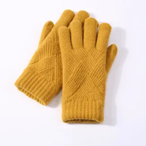 Detailed view of yellow winter knit gloves with soft fabric and classic textured pattern.