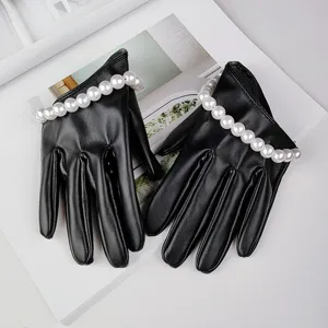 Black short faux leather gloves with pearl wrist trim, perfect for cosplay and fashion photo.