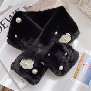 Close-up detail of the plush black faux fur scarf with pearls and white camellia flowers.