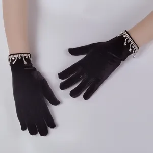 Women black velvet gloves with rhinestone tassel wrist detail, elegant fashion party wear.