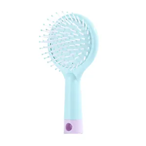 Mini cute air cushion hair brush with round shape light blue handle and white bristles.