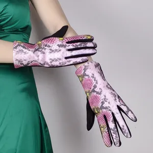 Close-up detail of women's pink snakeskin print fleece-lined touchscreen winter gloves.