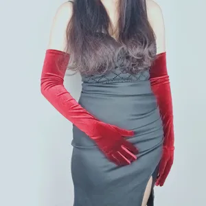 Red velvet long gloves detail shot, retro evening dress party accessory, soft fabric smooth touch.