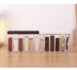 Detailed view of clear plastic spice jars set with dual lids for kitchen condiment storage.