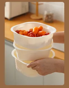Square kitchen draining basket detail view, thick plastic colander for washing vegetables.