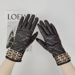 Women's winter warm black PU leather gloves featuring elegant quilted design and chic gold metal chain.
