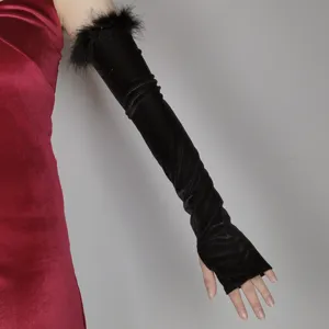 Detailed view of black velvet feather fingerless long gloves for elegant evening party.