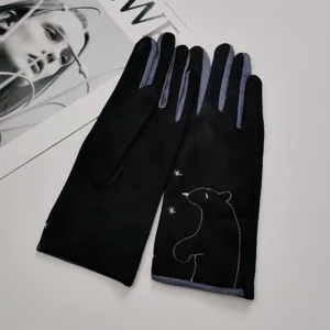 Detailed view of women's winter black suede gloves with cute bear embroidery pattern.