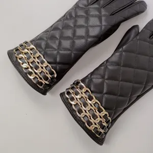 Women's elegant black quilted PU leather gloves with luxury gold chain detail for winter