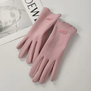 Detail view of women's winter warm pink touch screen gloves with cute velvet design.