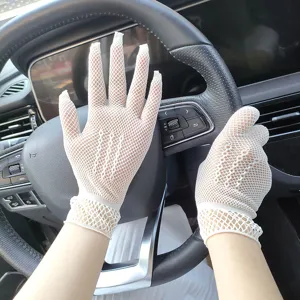 Detailed close-up of white mesh lace hollow gloves, elegant bridal and summer sun protection.