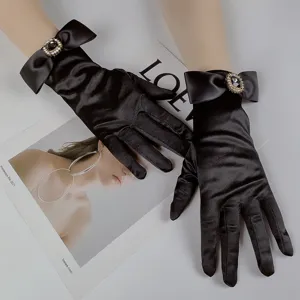 Exquisite black satin evening gloves with sparkling rhinestone bows, ideal bridal party accessories.
