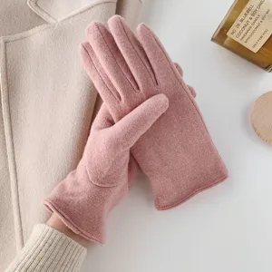 Close-up detail of women's pink knitted winter warm gloves, soft fabric texture view.