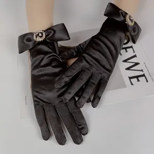 Exquisite black satin gloves featuring elegant bows and sparkling rhinestones for chic bridal wear.