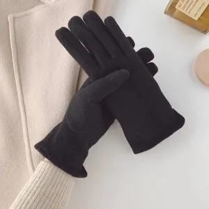 Close-up detail of women winter black wool gloves with touchscreen fingers on flat lay.
