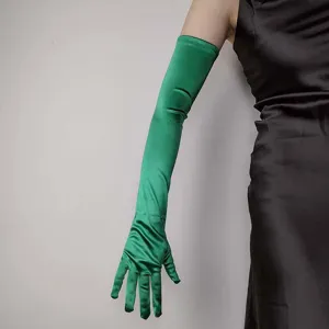 Close-up detail of smooth green satin long gloves, showcasing fabric texture and fit.