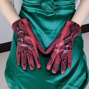 Close-up detail of women's python print faux suede thermal gloves, autumn winter cycling gear.