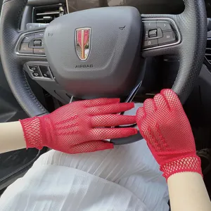 Detail view of red mesh lace gloves, hollow sun protection stretch bridal gloves in car.