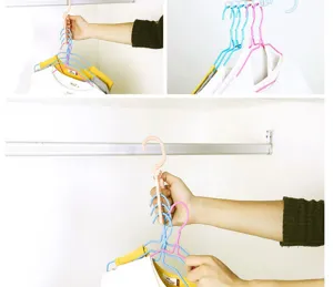 Multi-hole magic clothes hanger with handle, rotating closet organizer for space saving.