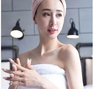 Soft coral fleece hair drying cap in pink showcasing highly absorbent texture detail.