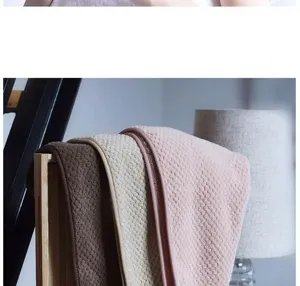 Detailed shot of coral fleece hair drying towel featuring soft pineapple grid texture.