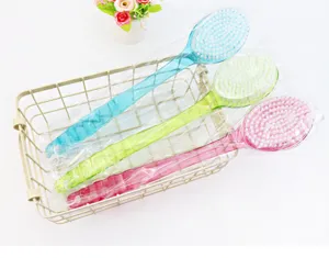Detailed view of colorful long handled bath brushes in a wire basket, perfect for scrubbing.