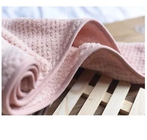 Detailed close up of soft pink coral fleece dry hair towel with thick waffle texture fabric