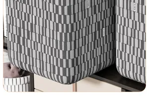 Close-up detail of grey geometric pattern fabric storage box showing texture and neat stitching.