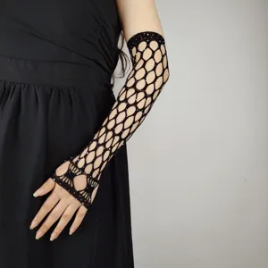 Close-up detail of black rhinestone fishnet long fingerless gloves showing sparkling crystal accents.