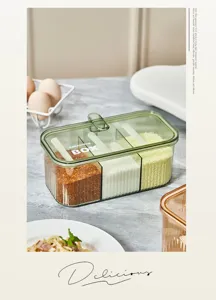 Transparent multi-compartment seasoning box with spoons, perfect for kitchen use.