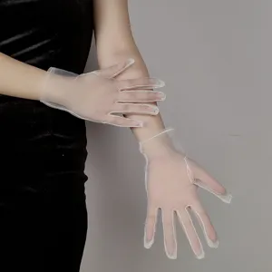 Detailed view of sheer white mesh bridal gloves, highlighting soft texture and design.