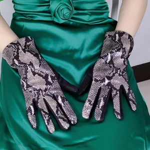 Detailed view of women's snakeskin pattern faux suede gloves, fashion winter warm accessory.