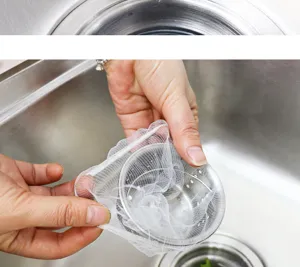 Detailed view of kitchen sink strainer with white mesh filter bag for debris filtering.