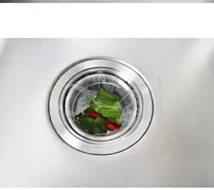 Close up view of kitchen sink strainer mesh bag installed in stainless steel drain, detail shot.