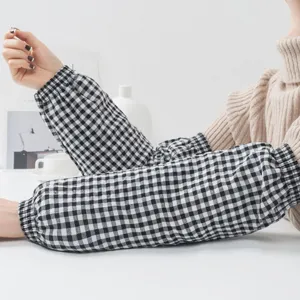 Detailed view of black and white plaid oversleeves with comfortable elastic cuffs for daily use.
