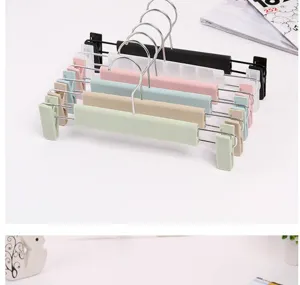 Multifunctional plastic pants hangers with clips, assorted colors, durable home organizer.