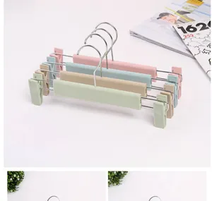 Multi-layer plastic pants hangers with clips, colorful trouser racks for home organization.