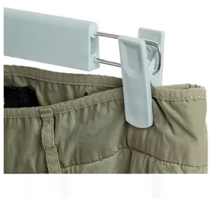 Close-up detail of plastic pants hanger clip showing sturdy metal wire and durable plastic structure.