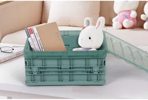 Green plastic folding storage box for desktop organization, toy and clothes container.