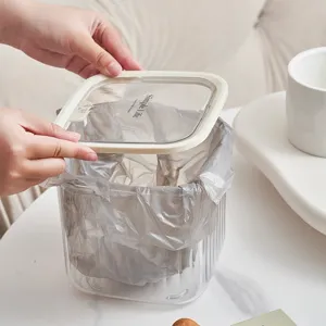 Clear desktop trash can with lid, transparent plastic storage bin for home and kitchen use.