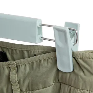 Plastic pants hanger with clips for home closet organization and clothes drying daily use.