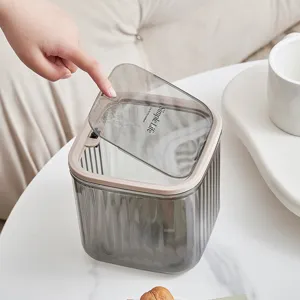 Transparent plastic desktop trash can with press lid for home kitchen and office use.