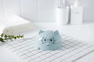 Blue plastic soap dish with cute cat ears and glasses design for bathroom countertop use.