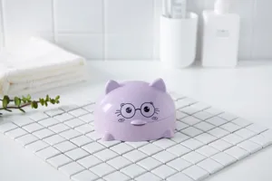 Large purple plastic soap dish with cat face design, covered draining holder for bathroom use.