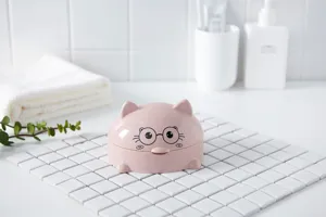 Large covered plastic cartoon cat soap dish with draining design for bathroom sink use detail.