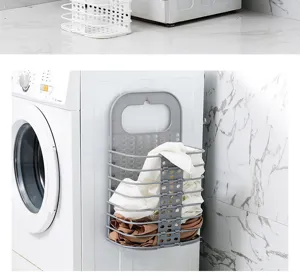 Detail view of the foldable plastic laundry basket mounted on washing machine side, practical.